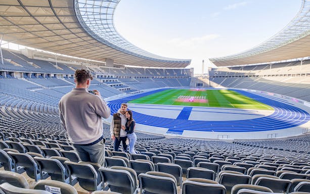 Guests exploring Olympiastadion Berlin, iconic sports venue in Germany.