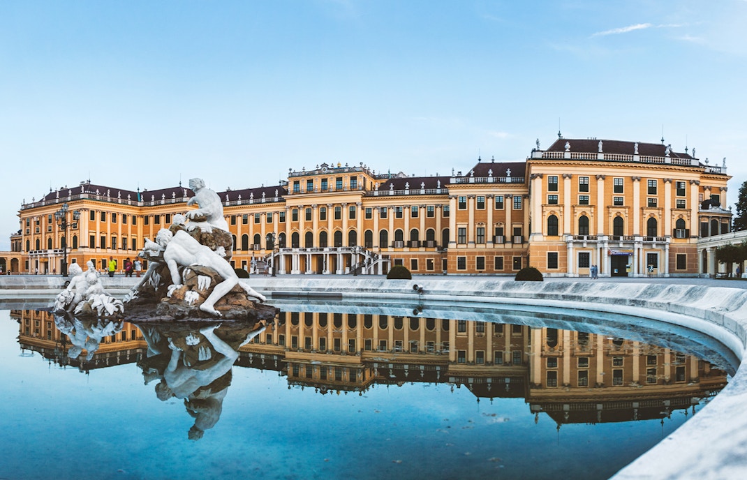 Schonbrunn Palace with Neptune Fountain reflection in Vienna, Austria.