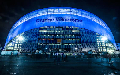 Orange Vélodrome stadium illuminated at night, Marseille tour.