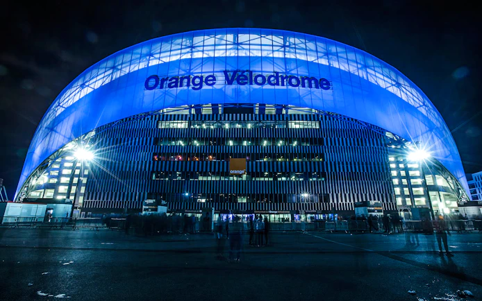 Orange Vélodrome stadium illuminated at night, Marseille tour.