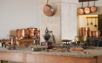 Kitchen tools and copper pots in the historic kitchen of Pena Palace, Sintra, Portugal.