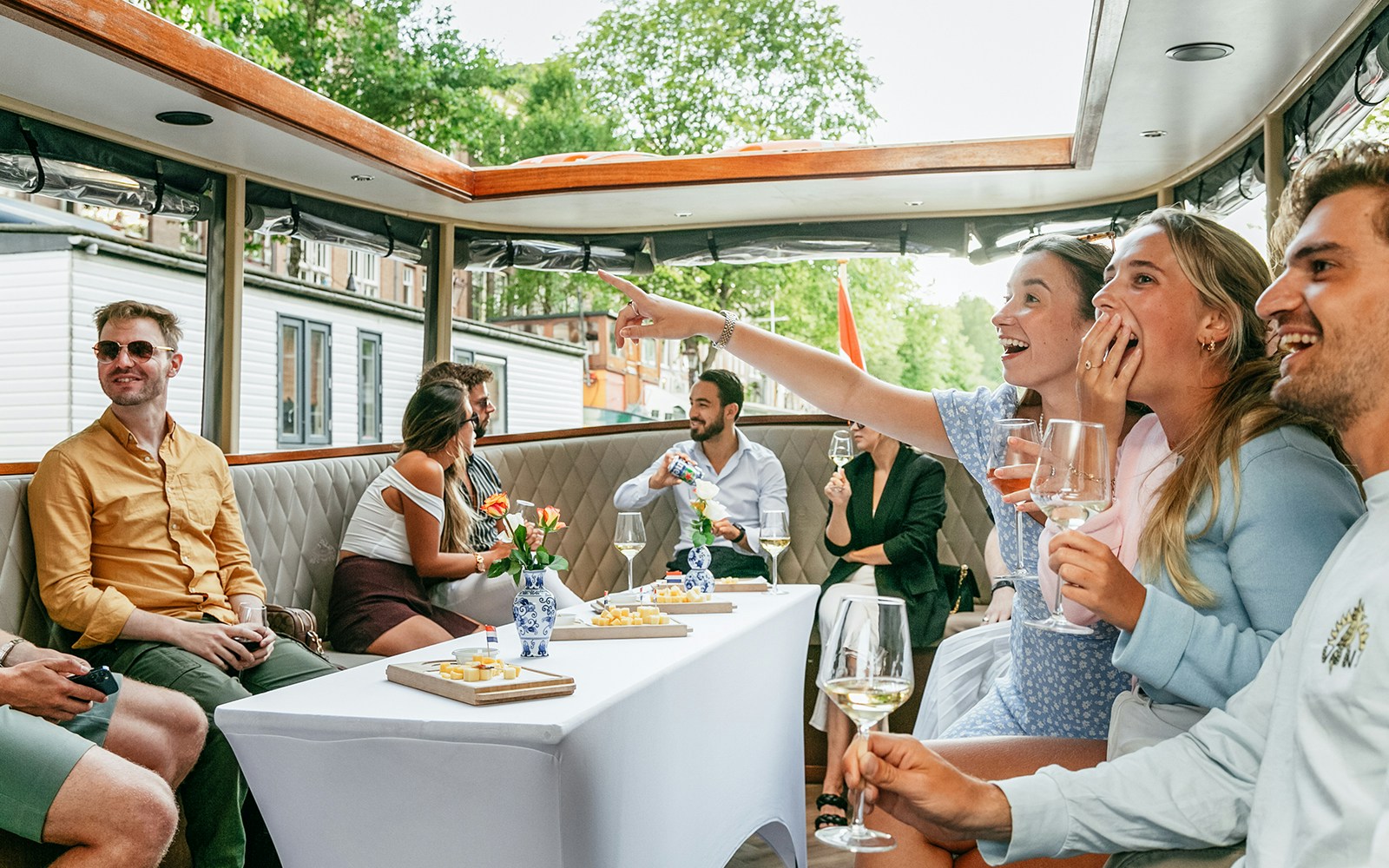 Amsterdam canal cruise boat with passengers enjoying unlimited drinks.