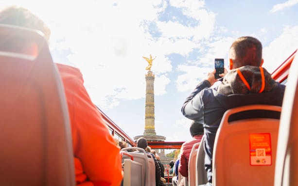 Open-top bus view of Berlin's Victory Column on a sightseeing tour.