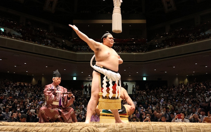 Sumo wrestler performing ritual at Nagoya Grand Sumo Tournament in Japan.
