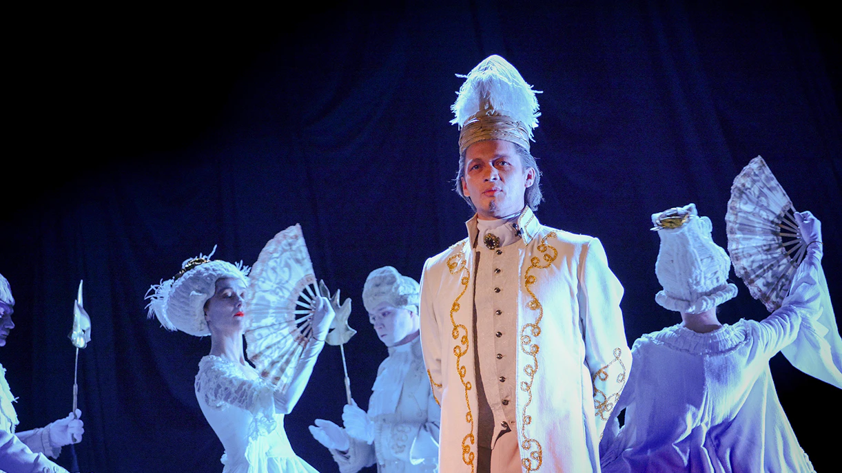Performers in period costumes on stage during an operetta.