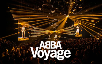 ABBA Voyage Westend show with vibrant stage lights and audience.