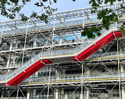 Centre Pompidou exterior with red escalators and exposed structural design in Paris.
