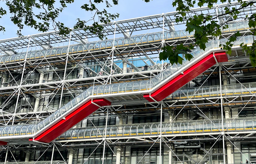 Centre Pompidou exterior with red escalators and exposed structural design in Paris.