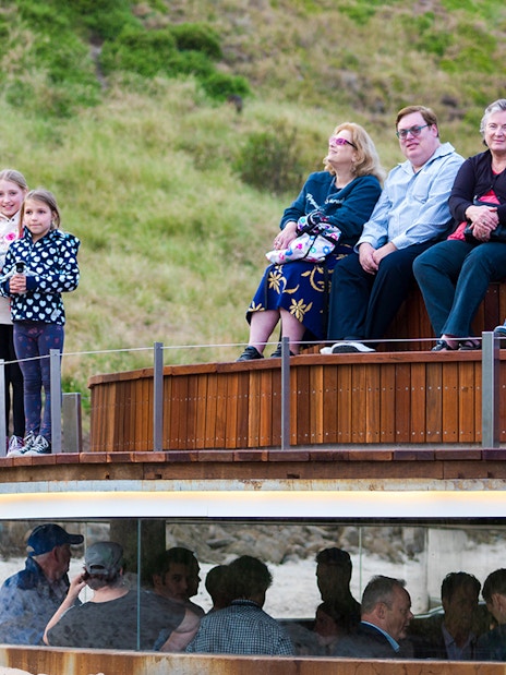 Visitors seated at Phillip Island Nature Parks viewing area for Penguin Parade.