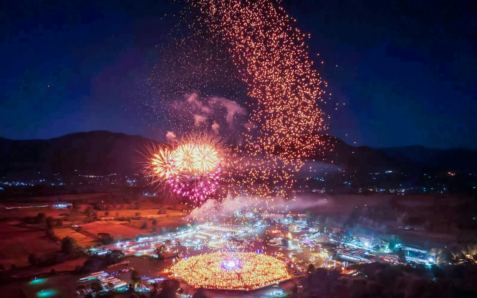 Aerial view of Yipeng Lantern Festival in Chiang Mai, Thailand, with thousands of lanterns illuminating the night sky.