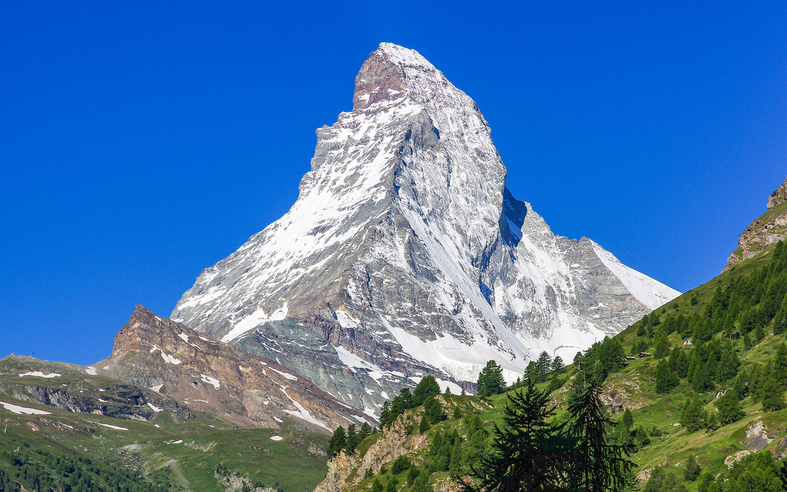 Matterhorn peak with snow, viewed from a helicopter tour in the Swiss Alps.