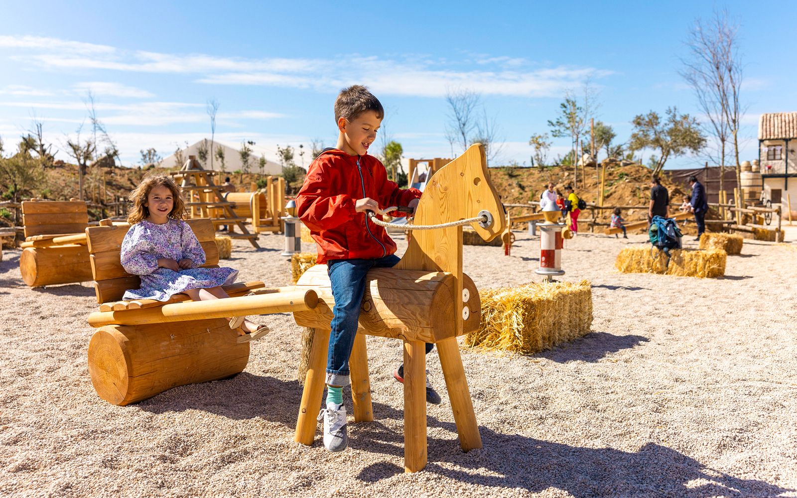 Children playing on wooden structures at Puy du Fou España park.