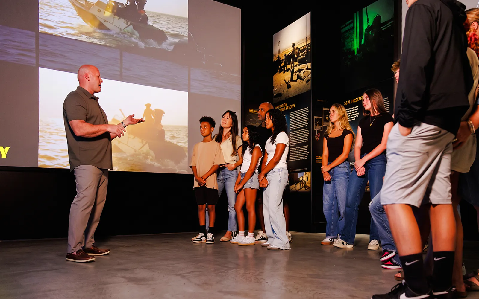 Group tour at The National Navy SEAL Museum, San Diego, with guide explaining exhibits.