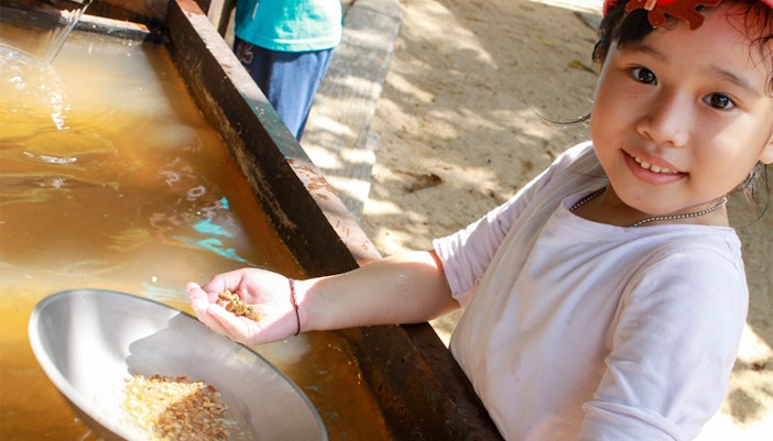 Children exploring interactive exhibits at ESCAPE Penang Discovery Dig, Malaysia.
