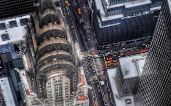Aerial view of the Chrysler Building in New York City with yellow taxis below.