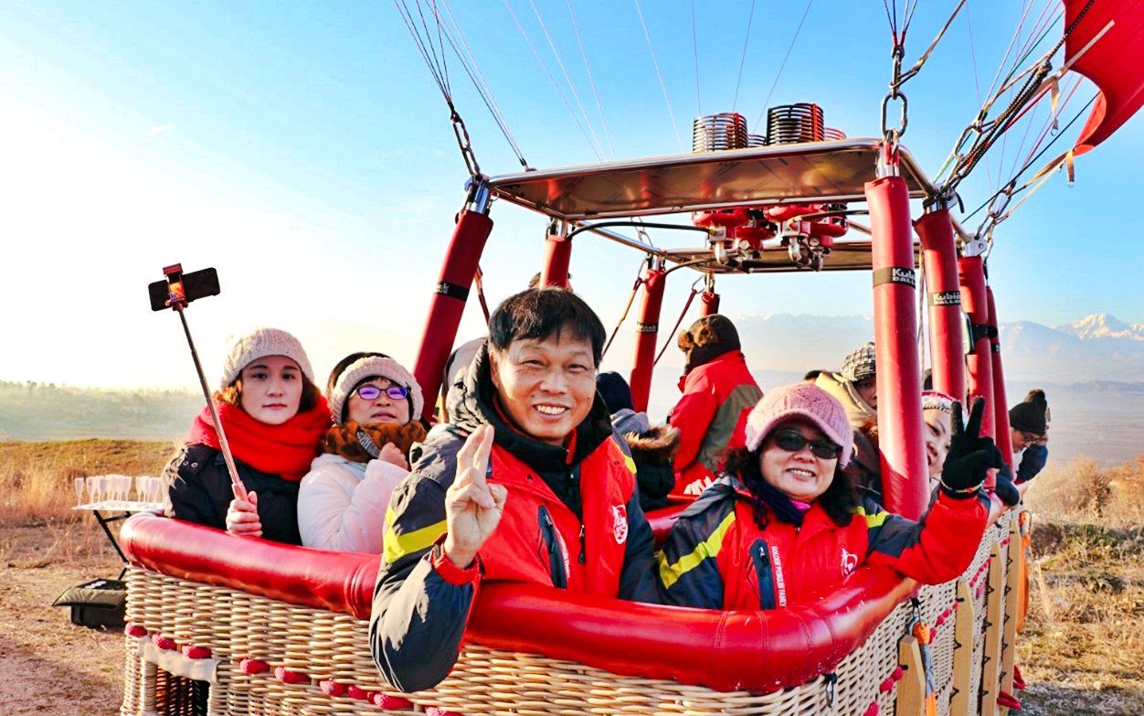 Tourists in a hot air balloon preparing for flight in Pamukkale, Turkey.