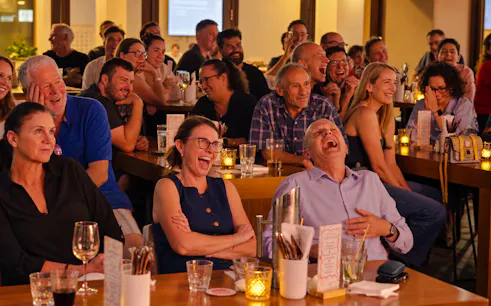 Audience laughing at a live stand-up comedy show in Sydney.