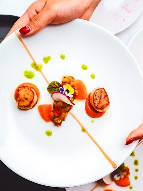 Scallops and garnishes served on a plate during the Gold Penfolds Dinner & Drinks Cruise, Sydney Harbour.