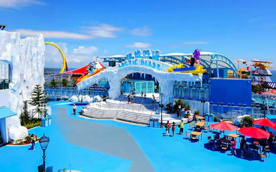 Ocean Park's Arctic Blast entrance with colorful rides and ice-themed decor.