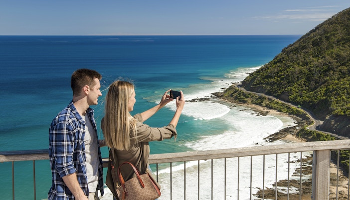 Couple enjoying scenic view from Teddy's Lookout on Great Ocean Road, Melbourne.