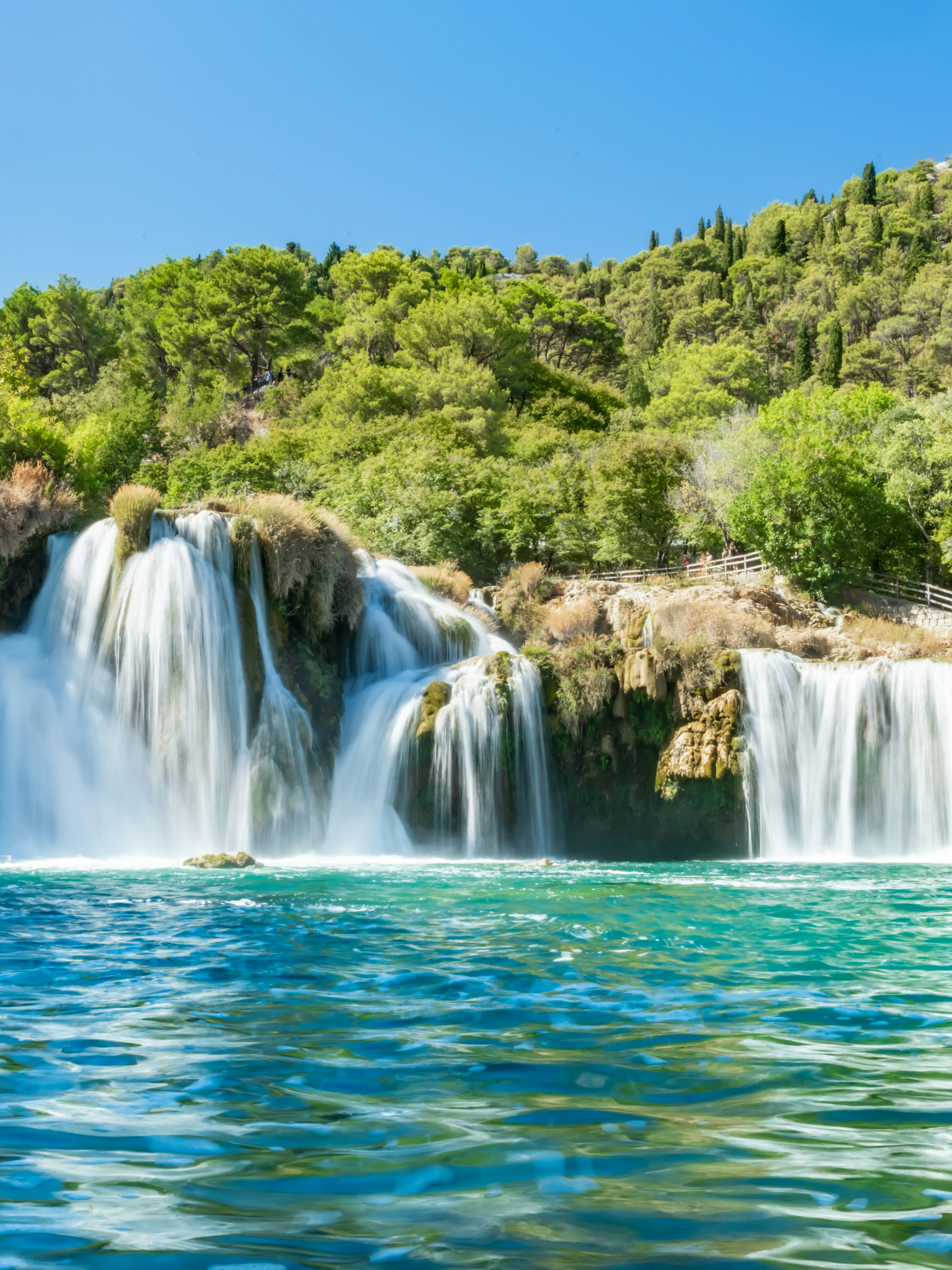 Waterfall Skradinski buk in Krka National Park, Croatia, surrounded by lush greenery.