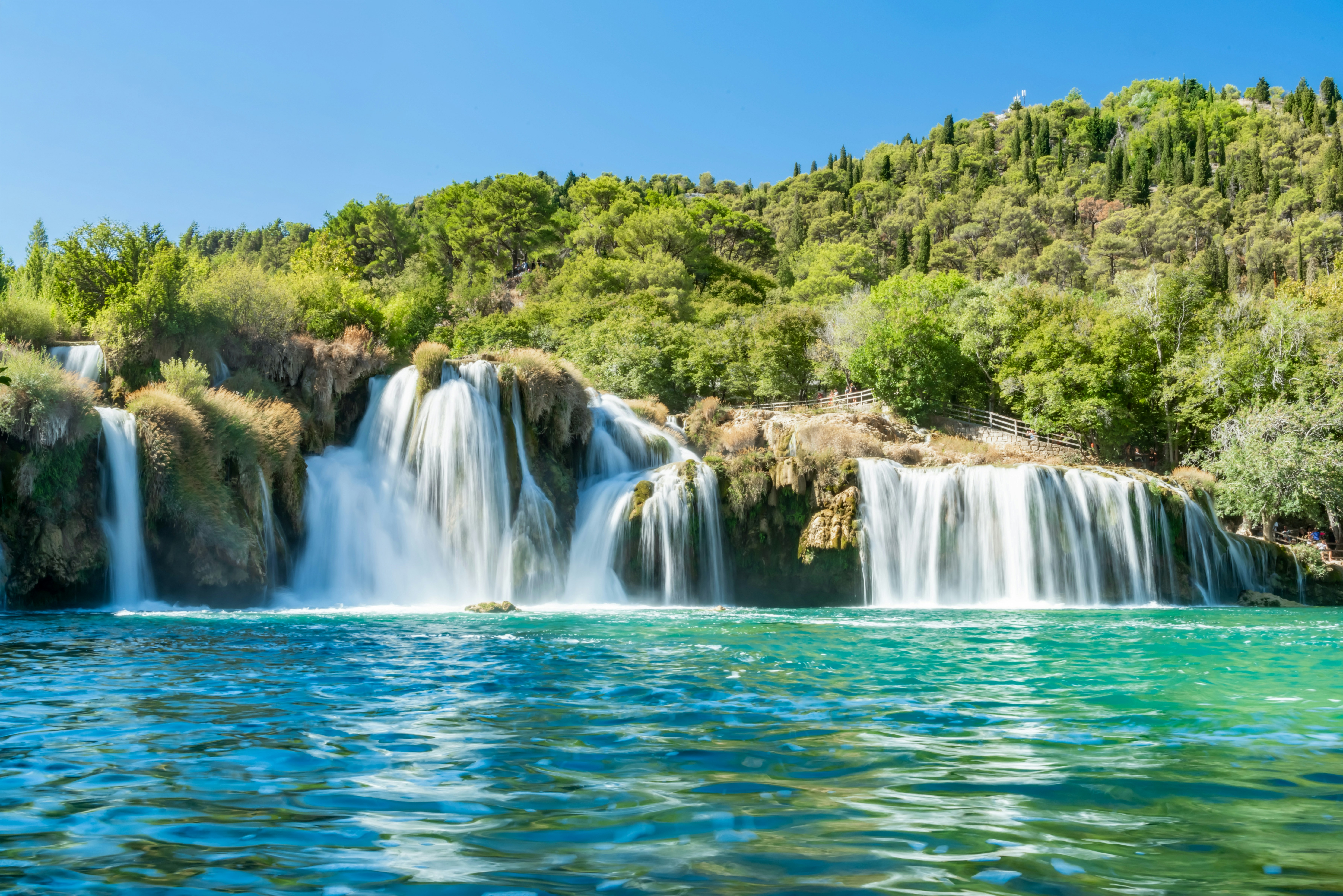 Waterfall Skradinski buk in Krka National Park, Croatia, surrounded by lush greenery.