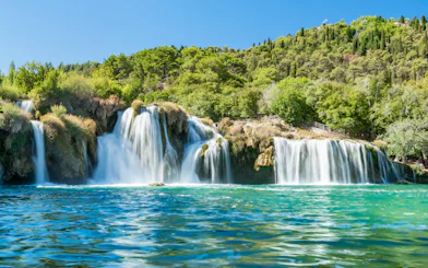 Waterfall Skradinski buk in Krka National Park, Croatia, surrounded by lush greenery.