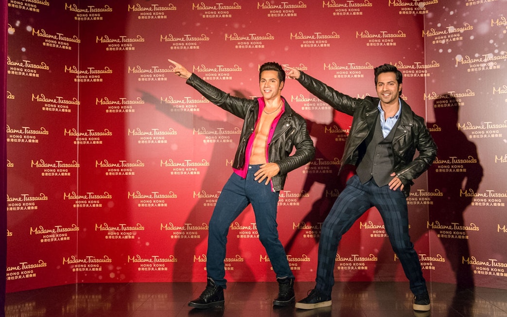 Wax figures in leather jackets at Madame Tussauds Hong Kong exhibit.
