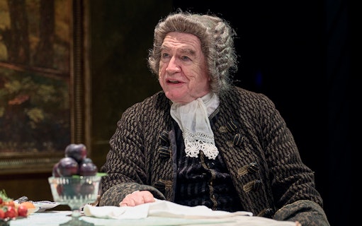 Actor in period costume seated at a table with fruit, related to The Score.