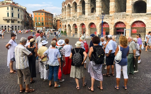 Tour group exploring Verona Arena in Verona city, Italy.