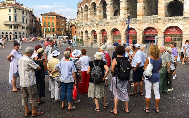 Tour group exploring Verona Arena in Verona city, Italy.