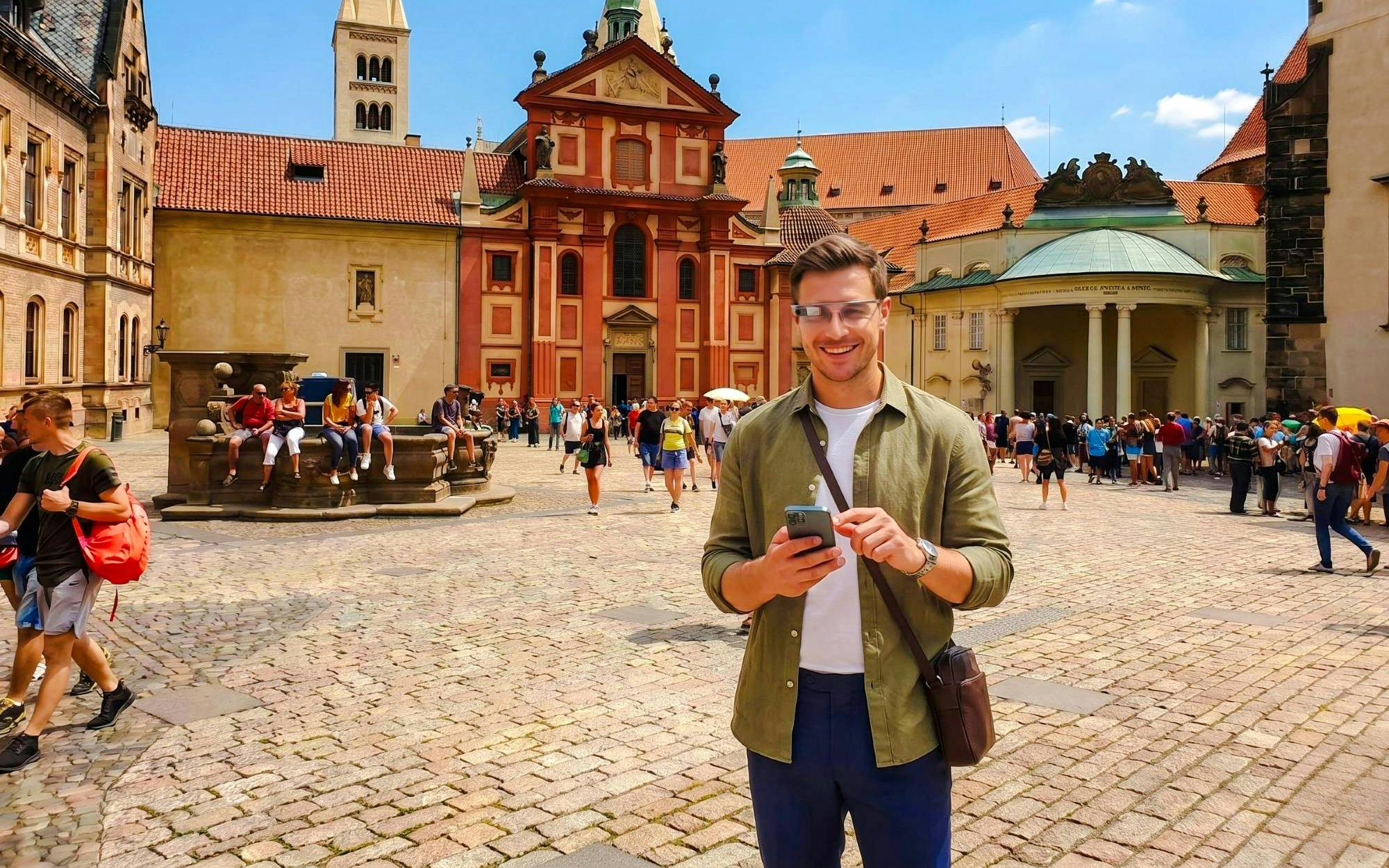Guests using AR glasses at Prague Castle courtyard during Time Travel Tour.