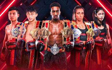 Champions with belts and gloves at Rajadamnern Stadium.