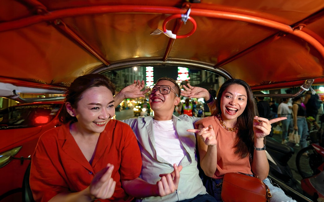 Group enjoying a tuk-tuk ride during Bangkok Night Tour.