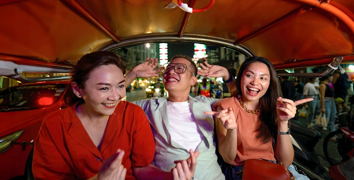 Group enjoying a tuk-tuk ride during Bangkok Night Tour.