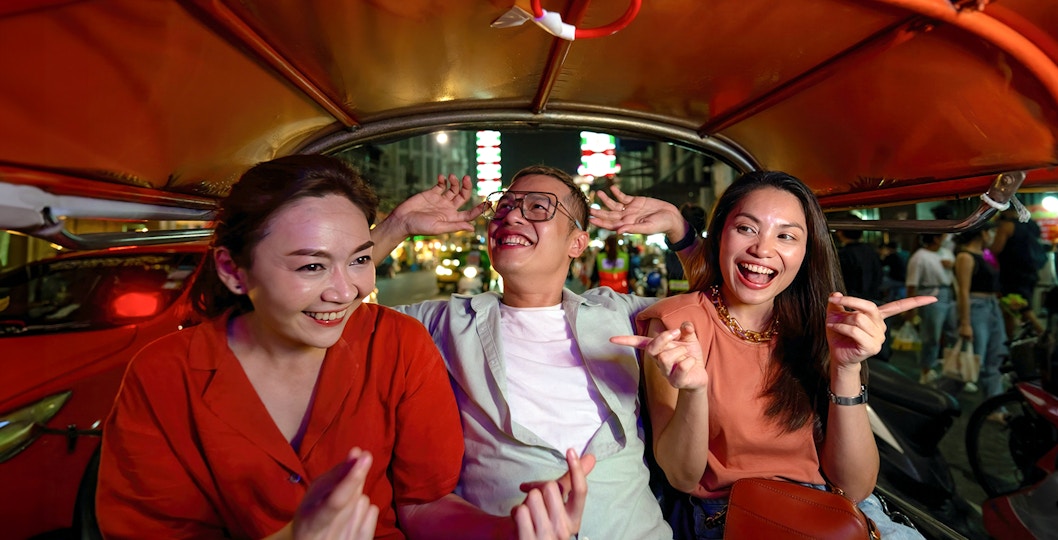 Group enjoying a tuk-tuk ride during Bangkok Night Tour.