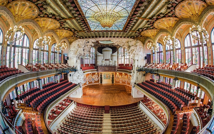 Concert Hall interior at Palau de la Musica Catalana, Barcelona, featuring stained glass and ornate architecture.