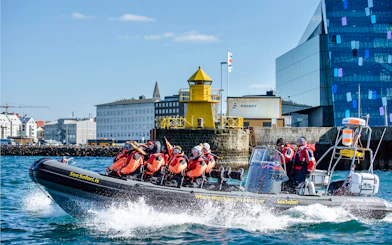 Guests on RIB speedboat for whale watching and puffin tour departing Reykjavik harbor.