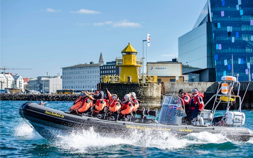 Guests on RIB speedboat for whale watching and puffin tour departing Reykjavik harbor.