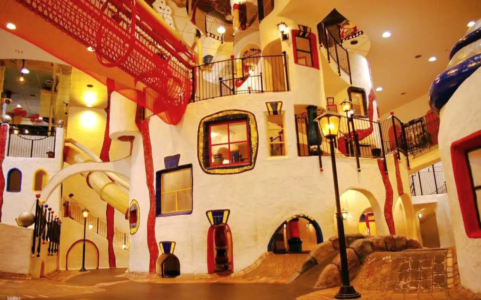 Indoor play area with colorful slides and climbing structures at Kids Plaza Osaka.