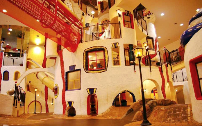 Indoor play area with colorful slides and climbing structures at Kids Plaza Osaka.