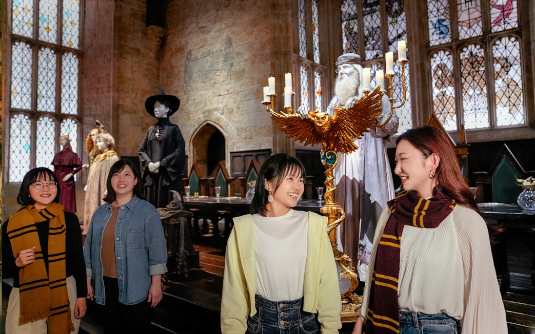 Visitors exploring the Great Hall at Hogwarts, Warner Bros. Studio Tour Tokyo.