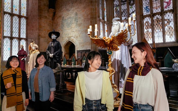 Visitors exploring the Great Hall at Hogwarts, Warner Bros. Studio Tour Tokyo.