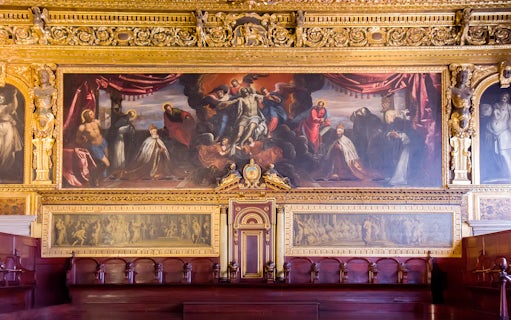 Doge Palace chamber with ornate gold detailing and historical paintings in Venice.