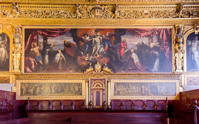 Doge Palace chamber with ornate gold detailing and historical paintings in Venice.