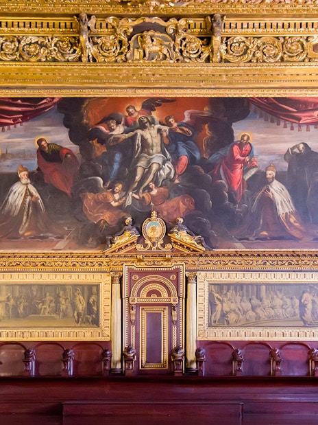 Doge Palace chamber with ornate gold detailing and historical paintings in Venice.