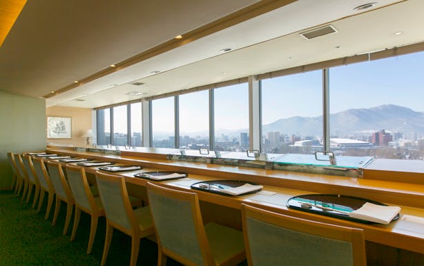 Dining area with city and mountain views at Hokkaido Nadaman Sapporo saryo branch.