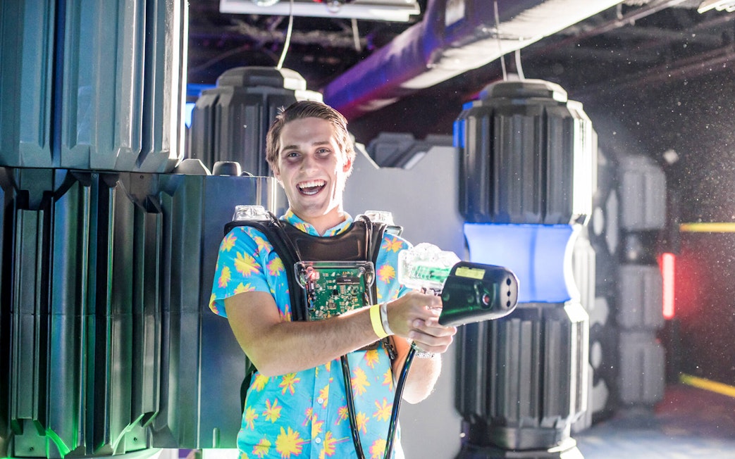 Person enjoying laser tag at Wonderworks indoor attraction.