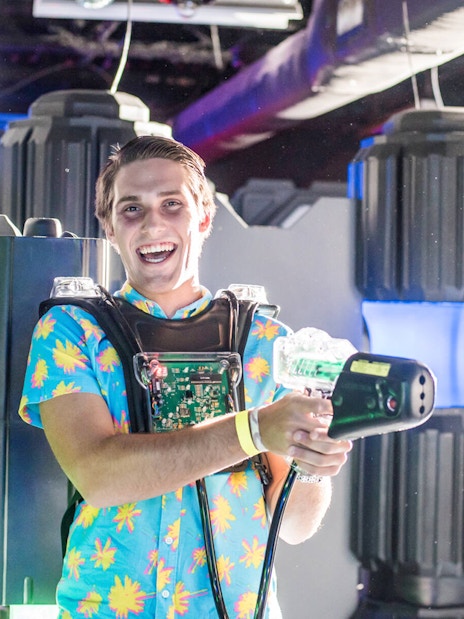 Person enjoying laser tag at Wonderworks indoor attraction.