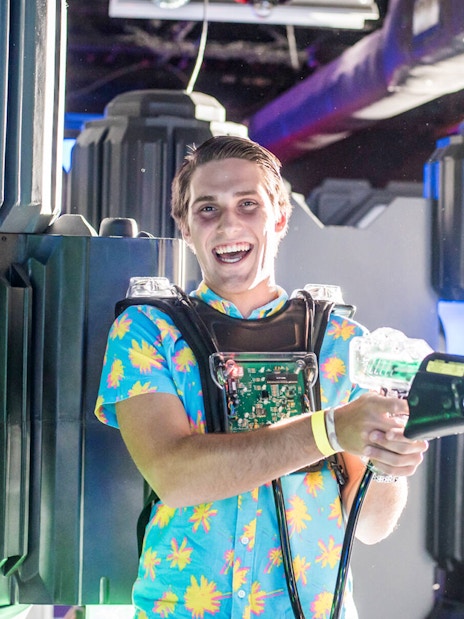 Person enjoying laser tag at Wonderworks indoor attraction.